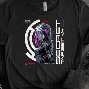 May include: Black t-shirt with a graphic design of a woman with headphones and a futuristic design. The text "SECRET TARGET" is on the right side of the design.