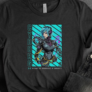 May include: A black t-shirt with a graphic of a female cyborg with blue hair and a blue and pink background. The text "CYBORG" is written vertically on the left side of the graphic. The text "BEYOND THE BOUNDARIES OF HUMANITY" is written below the graphic.