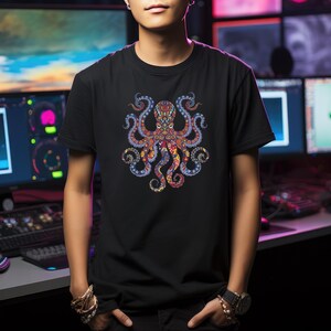 May include: Black t-shirt featuring a colorful octopus design. The octopus has intricate patterns in shades of red, blue, orange, and yellow. The design is centered on the shirt, creating a bold and eye-catching graphic.
