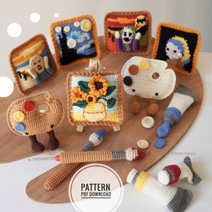 May include: Crochet amigurumi art supplies, including paint tubes, paintbrushes, and a palette. There are also five framed crochet pictures of famous paintings, including The Starry Night, The Scream, and Girl with a Pearl Earring. The text "PATTERN PDF DOWNLOAD" is visible in the image.