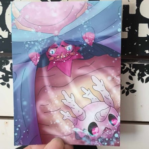 May include: A pink and blue illustration of two Pokemon, one with a star-shaped head and the other with a round head and multiple arms. The Pokemon with the star-shaped head is peeking out from behind the other Pokemon.