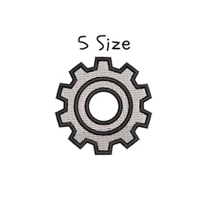May include: Embroidered patch of a gear with a black outline and a textured gray fill. The text "S Size" is above the gear in black, handwritten-style lettering. The gear has a circular center.