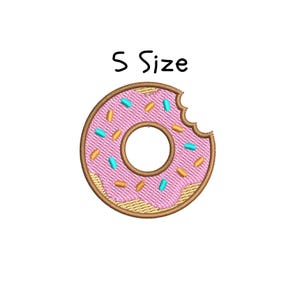 May include: A pink donut with a bite taken out of it. The donut is decorated with blue and orange sprinkles. The text "S Size" is above the donut.