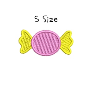 May include: Embroidered candy design in pink and yellow. The candy has a circular pink center with a textured pattern and yellow, wing-shaped ends. The text "S Size" is above the candy.