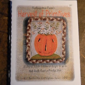May include: A book titled "Harvest of Primitives" by Notforgotten Farm's. The cover features a hand-stitched pumpkin with a green stem and leaves. The book contains 10 original autumn and Halloween designs for needle punch or primitive stitch.
