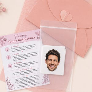 May include: A temporary tattoo featuring a photographic portrait of a smiling man with dark hair, packaged in a clear plastic bag with a printed instruction card titled Temporary Tattoo Instructions and a dusty rose envelope with a heart seal.