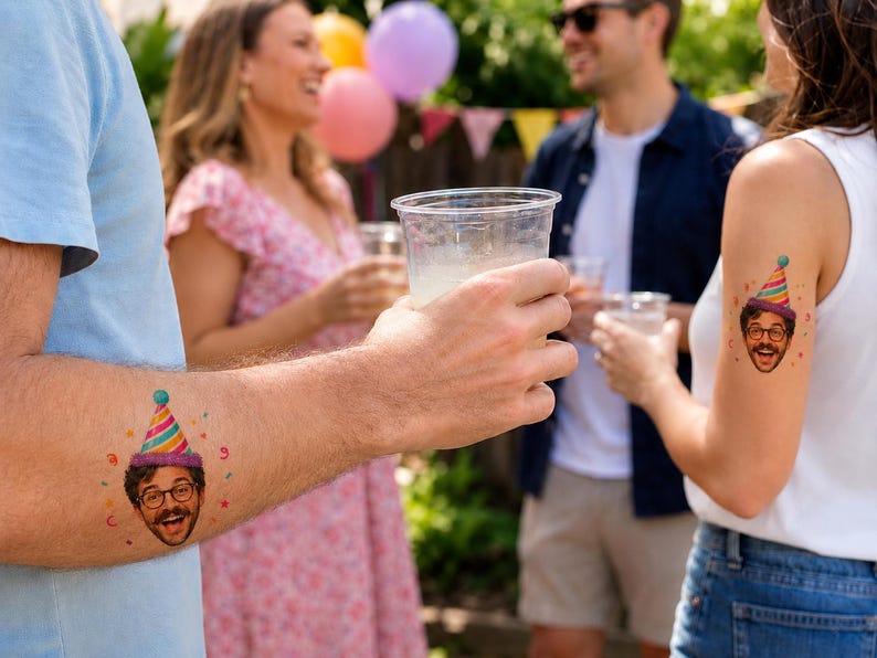 May include: A temporary tattoo featuring a colorful illustration of a person's face with a mustache, glasses, and a striped party hat. The design includes small confetti accents in red, yellow, and green, applied to the skin of two different individuals.