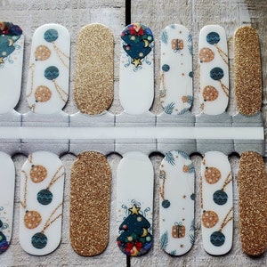 May include: A set of 10 nail wraps featuring a Christmas theme with baubles, a Christmas tree, and gold glitter. The nail wraps are designed to be applied to fingernails.