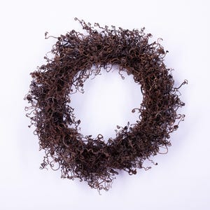 May include: A circular wreath composed of dried, curly brown twigs, set against a white background. The twigs are densely packed, creating a textured, natural appearance. This decorative wreath is suitable for seasonal home decor.
