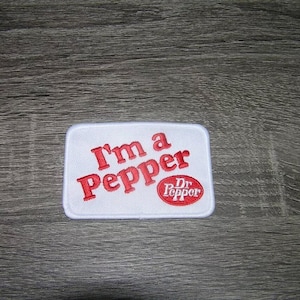May include: White embroidered patch with red text that reads "I'm a Pepper" and a red Dr Pepper logo.