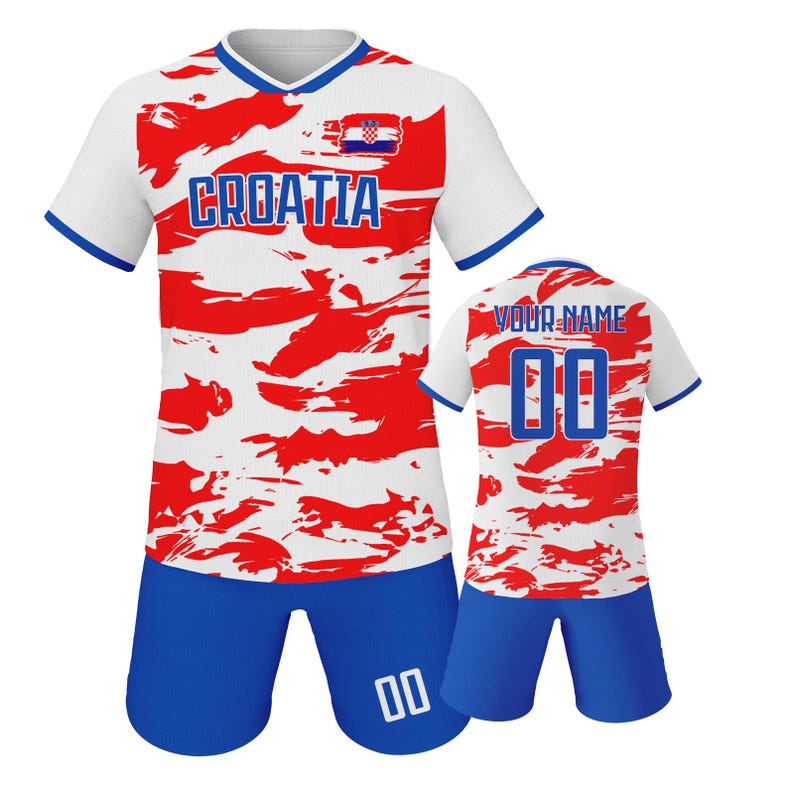 May include: A white and red Croatia soccer uniform with blue shorts. The jersey has the word "CROATIA" across the front and the Croatian flag. The shorts and jersey have the number "00".