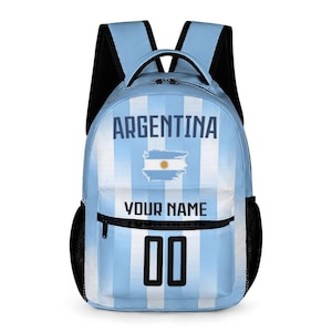May include: A light blue and white striped backpack featuring the text ARGENTINA at the top, a central graphic of the Argentine flag, the text YOUR NAME in the middle, and the number 00 in black at the bottom with black shoulder straps.