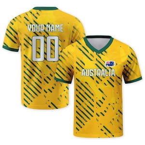 May include: A yellow and green V-neck jersey featuring diagonal stripes, the text AUSTRALIA with an Australian flag icon on the front, and the text YOUR NAME with the number 00 on the back. The design includes a dark green collar and sleeve trim.