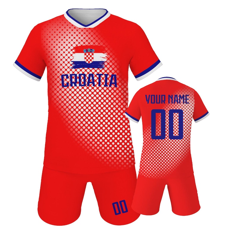 May include: A red Croatia soccer uniform set. The jersey features the Croatian flag and the word "CROATIA" in blue. The shorts have the number "00" in blue. The back of the jersey has the text "YOUR NAME" and the number "00".