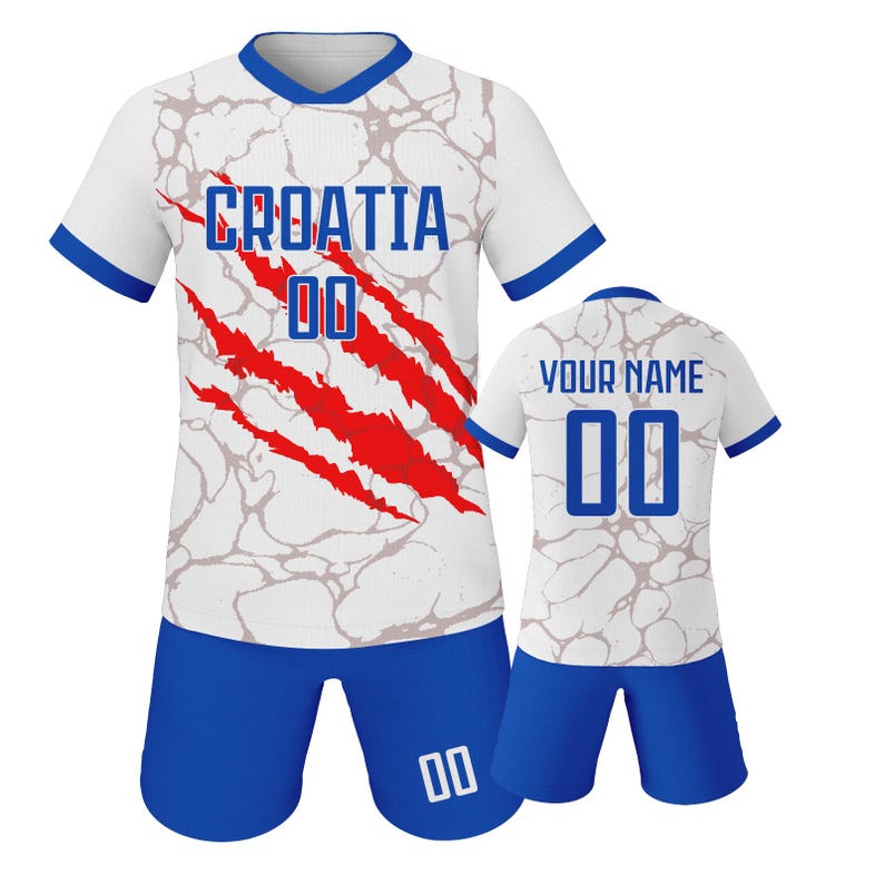 May include: A white and blue Croatia soccer uniform set. The jersey features the word "CROATIA" and the number "00" in blue, with red claw marks. The shorts are blue with the number "00". A second jersey is visible with "YOUR NAME" and the number "00".