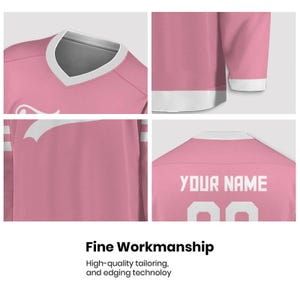 May include: Pink hockey jersey with white accents. The jersey features a V-neck collar and white stripes on the sleeves. The back of the jersey displays the text "YOUR NAME" above the number "00". The image also includes the text "Fine Workmanship".