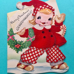 May include: A vintage Christmas card featuring a girl in a red and white checkered outfit holding a sign that says "Merry Christmas Granddaughter!"