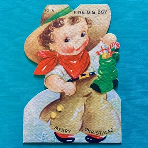 Tarjeta de felicitación navideña vintage para un buen niño grande con un disfraz de vaquero John G Scott Ilustración Gibson