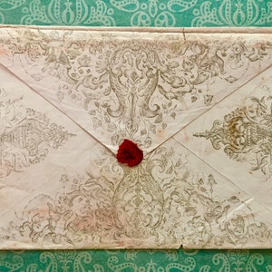 May include: A vintage envelope with a decorative design and a red wax seal.