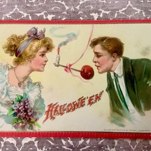 Postal vintage de Halloween Raphael Tuck and Sons Era eduardiana Hombre y mujer jugando al juego de fiesta