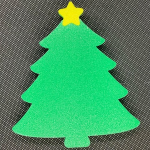 May include: A green felt Christmas tree with a yellow star on top. The tree is a simple, flat shape and would be great for crafts or decorations.