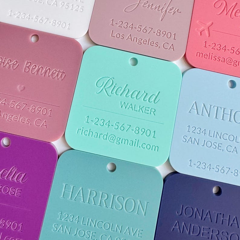 May include: A collection of colorful, square-shaped tags with rounded corners. Each tag features a name and contact information, including a phone number and email address. The tags are in various colors, including pink, blue, and purple.