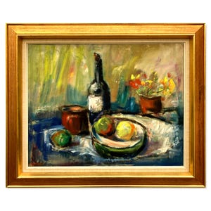 May include: Oil painting in a gold frame depicting a still life. The artwork shows a dark wine bottle, a bowl of fruit, a small pot, and a pot of flowers. The colour palette includes blues, greens, reds, and yellows.