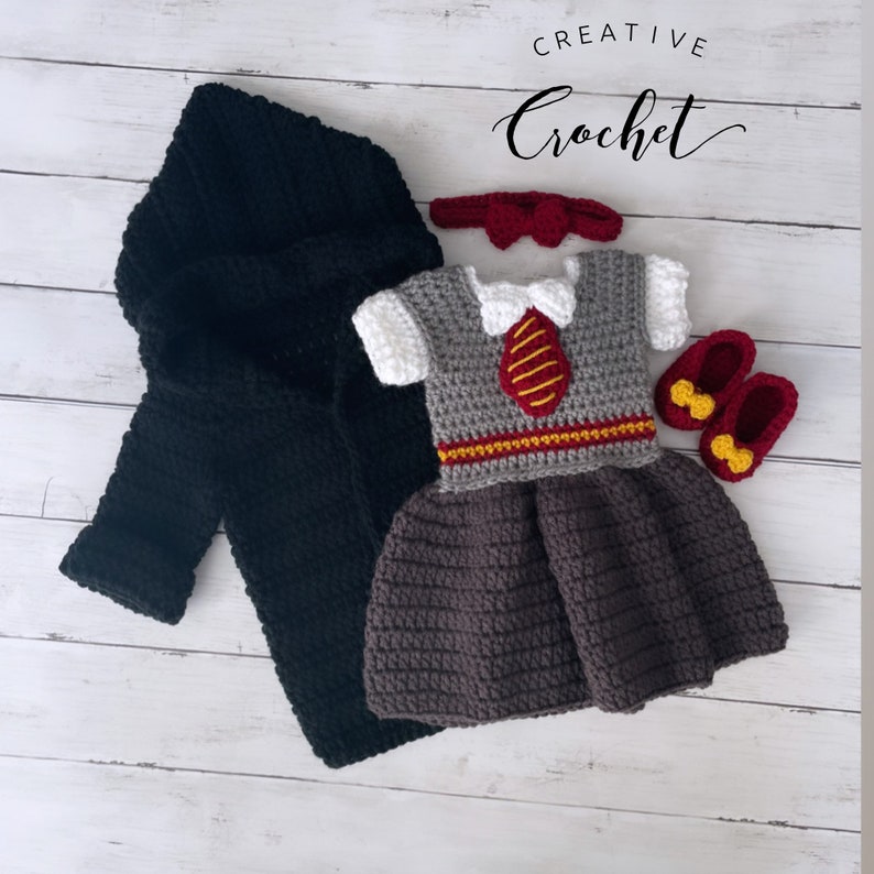 May include: A crocheted baby outfit in a Hogwarts theme. The outfit includes a black hooded robe, a grey and burgundy dress with a red tie, a red headband with a bow, and a pair of burgundy shoes with yellow bows.