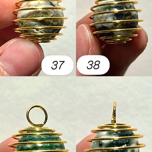 May include: Four gemstone pendants with gold-colored wire cage designs. The gemstones are spherical, with variations in color and pattern. The numbers 37, 38, 39, and 40 are printed below each pendant.