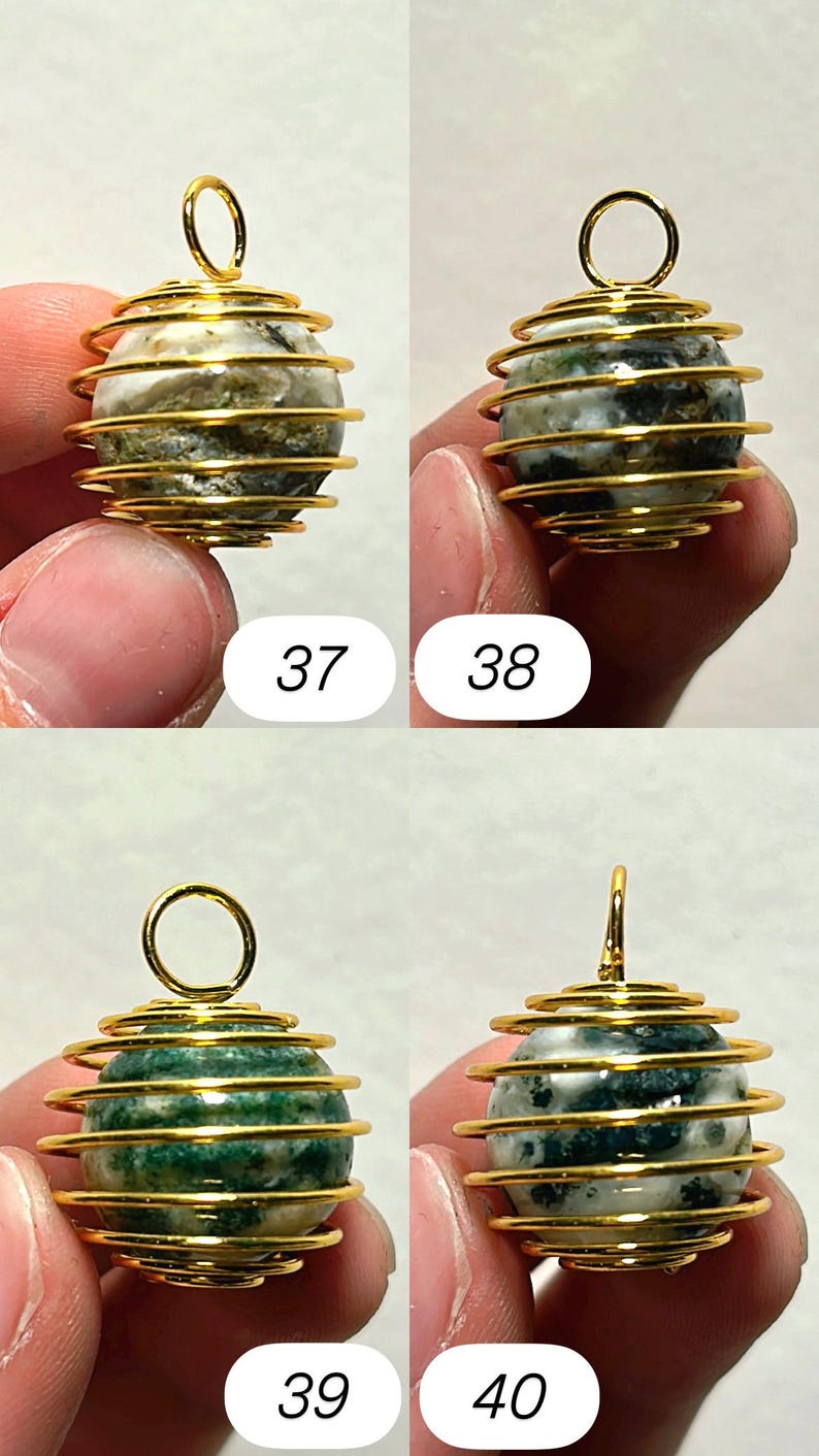 May include: Four gemstone pendants with gold-colored wire cage designs. The gemstones are spherical, with variations in color and pattern. The numbers 37, 38, 39, and 40 are printed below each pendant.