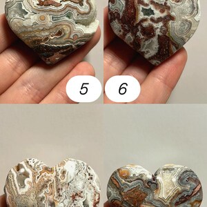 May include: Four heart-shaped stones with unique patterns and colors. The stones are numbered 5, 6, 7, and 8. The stones have a mix of colors, including brown, white, gray, and red. The stones are held in a hand.