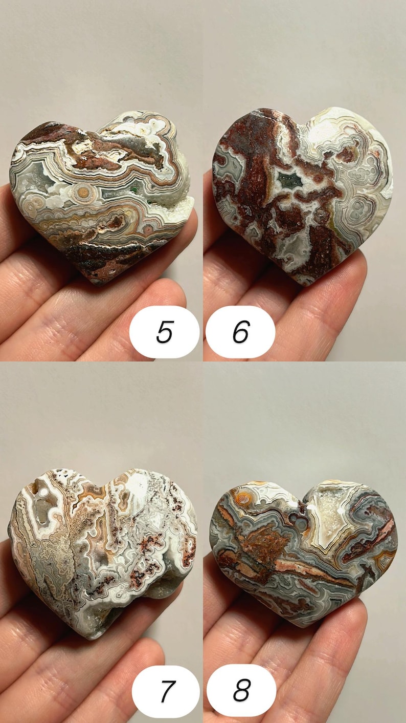 May include: Four heart-shaped stones with unique patterns and colors. The stones are numbered 5, 6, 7, and 8. The stones have a mix of colors, including brown, white, gray, and red. The stones are held in a hand.