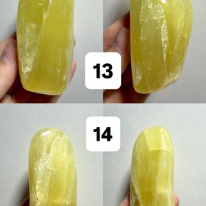 May include: Four views of a freeform, yellow-green crystal. The stone has a smooth, polished appearance with natural veining. The images are numbered 13 and 14. The text at the top reads "(Two sides - 1 Freeform)".