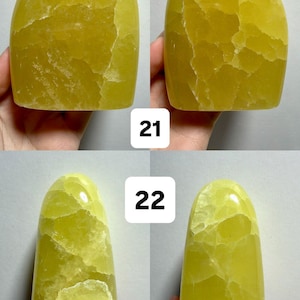 May include: Four views of a freeform, polished yellow calcite stone. The stone has a smooth, glossy surface with natural veining. The text "(Two sides - 1 Freeform)", "21", and "22" are visible in the image.