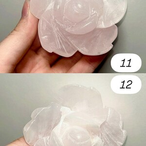 May include: Two rose quartz carvings, each depicting a detailed rose blossom. The carvings are a soft pink color and feature intricate petal details. The background is a neutral gray. Numbers 11 and 12 are visible in the image.