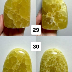 May include: Four views of a freeform, yellow-green stone with a textured surface. The stone has a rounded shape with a smooth, polished appearance. The numbers "29" and "30" are visible in the image.