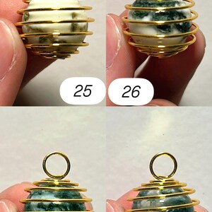 May include: Four gemstone pendants with gold-colored wire cage designs. The gemstones are white with green inclusions and green with white inclusions. Each pendant has a small loop at the top. Numbers 25, 26, 27, and 28 are visible.