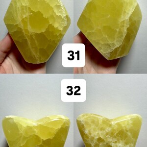 May include: Four yellow-green freeform gemstone carvings. Two are diamond-shaped, and two are heart-shaped. The gemstones have a textured surface. The image includes the text "(Two sides - 1 Freeform)" and numbers "31" and "32".