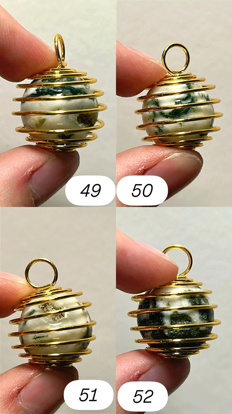 May include: A gold-colored wire-wrapped pendant with a round, off-white stone featuring green inclusions. The pendant has a loop at the top for hanging. Numbers 49, 50, 51, and 52 are visible in the image.