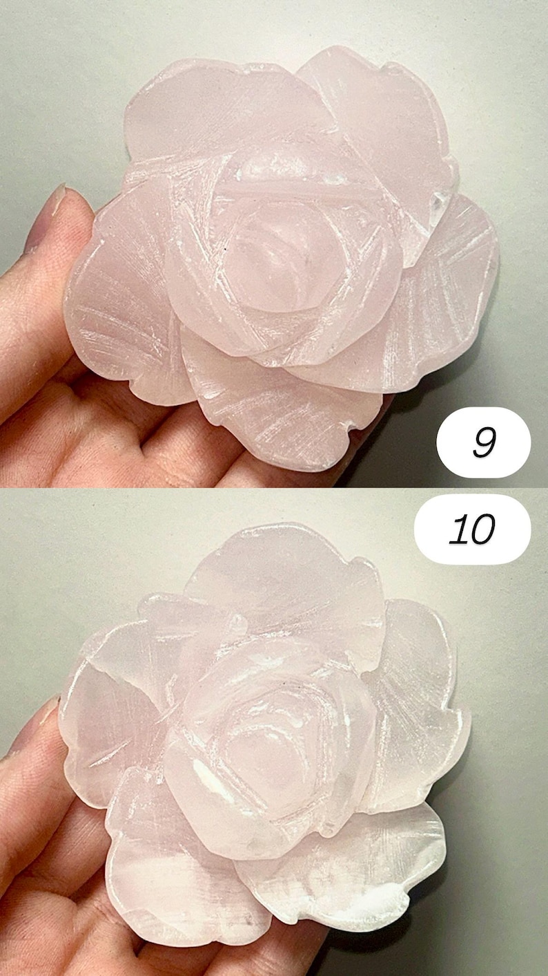 May include: A carved rose-shaped sculpture in a soft pink hue. The petals are detailed with delicate lines, creating a realistic floral design. The sculpture is held in a hand, showcasing its size and texture.