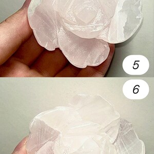 May include: A carved rose made of pale pink stone. The flower has multiple layers of petals, with detailed carving in the center. The stone has a translucent quality, and the overall effect is delicate and elegant.