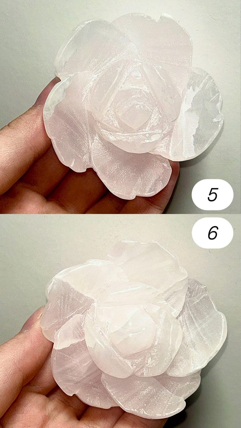 May include: A carved rose made of pale pink stone. The flower has multiple layers of petals, with detailed carving in the center. The stone has a translucent quality, and the overall effect is delicate and elegant.