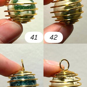 May include: Four gemstone pendants with gold-colored wire wrapping. Each pendant has a spherical stone with unique patterns and colors, including green, white, and blue. The pendants are numbered 41, 42, 43, and 44.