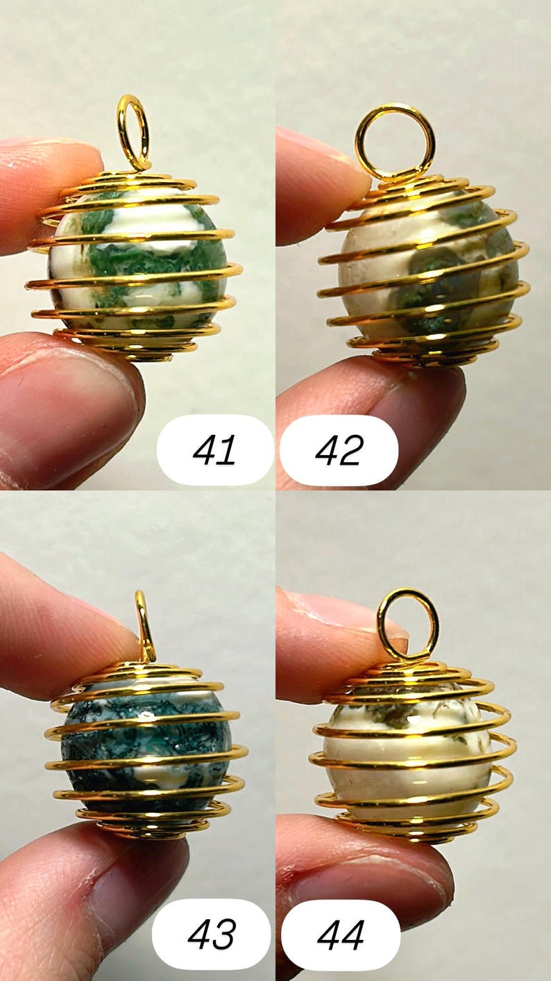 May include: Four gemstone pendants with gold-colored wire wrapping. Each pendant has a spherical stone with unique patterns and colors, including green, white, and blue. The pendants are numbered 41, 42, 43, and 44.