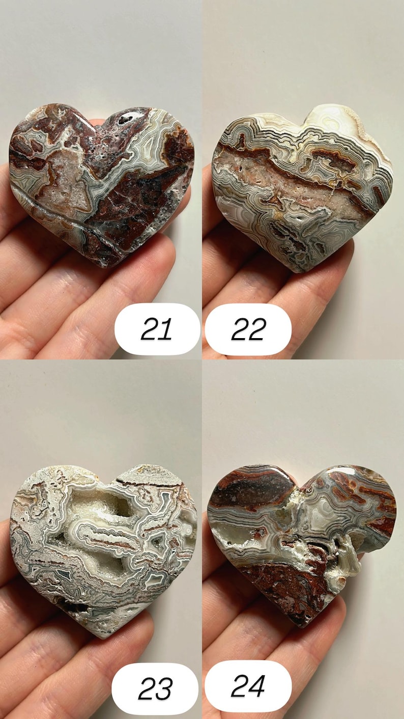 May include: Four heart-shaped stones with unique patterns and colors. The stones are shades of brown, white, and gray, with intricate veining. Each stone is numbered: 21, 22, 23, and 24. These decorative stones are ideal for collectors.
