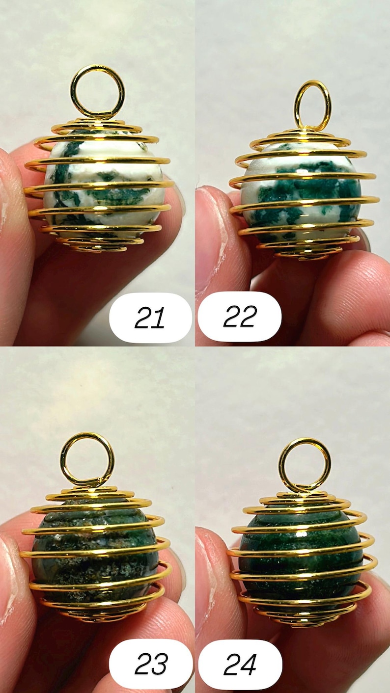 May include: Four gemstone pendants with gold-colored wire wrapping. The gemstones are spherical, with variations in color and pattern. Two pendants have white and green stones, while the other two are dark green. Each pendant has a loop at the top. Numbers 21, 22, 23, and 24 are visible.