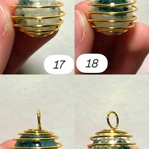 May include: Four gemstone pendants with gold-colored wire wrapping. Each pendant features a spherical stone in shades of green and white, encased in a spiral wire design. The numbers 17, 18, 19, and 20 are visible.