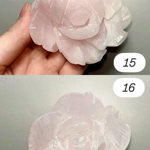May include: Two images of a carved rose made of pink quartz. The rose has detailed petals and a natural, translucent appearance. The images are numbered 15 and 16.