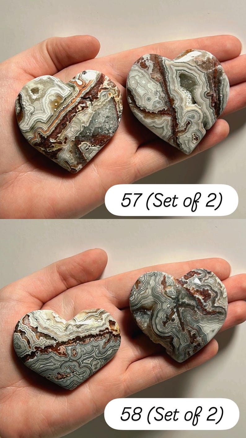 May include: Two heart-shaped stones with intricate patterns of gray, brown, and white. The stones are held in a hand. The text "57 (Set of 2)" and "58 (Set of 2)" are visible.