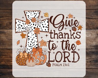 May include: A design featuring a cross with a dalmatian print, surrounded by flowers, pumpkins, and fall leaves. The text reads "Give thanks to the LORD" with "Psalm 136:1" below. The words "READY TO PRESS" and "CUSTOM DTF" are at the top and bottom.
